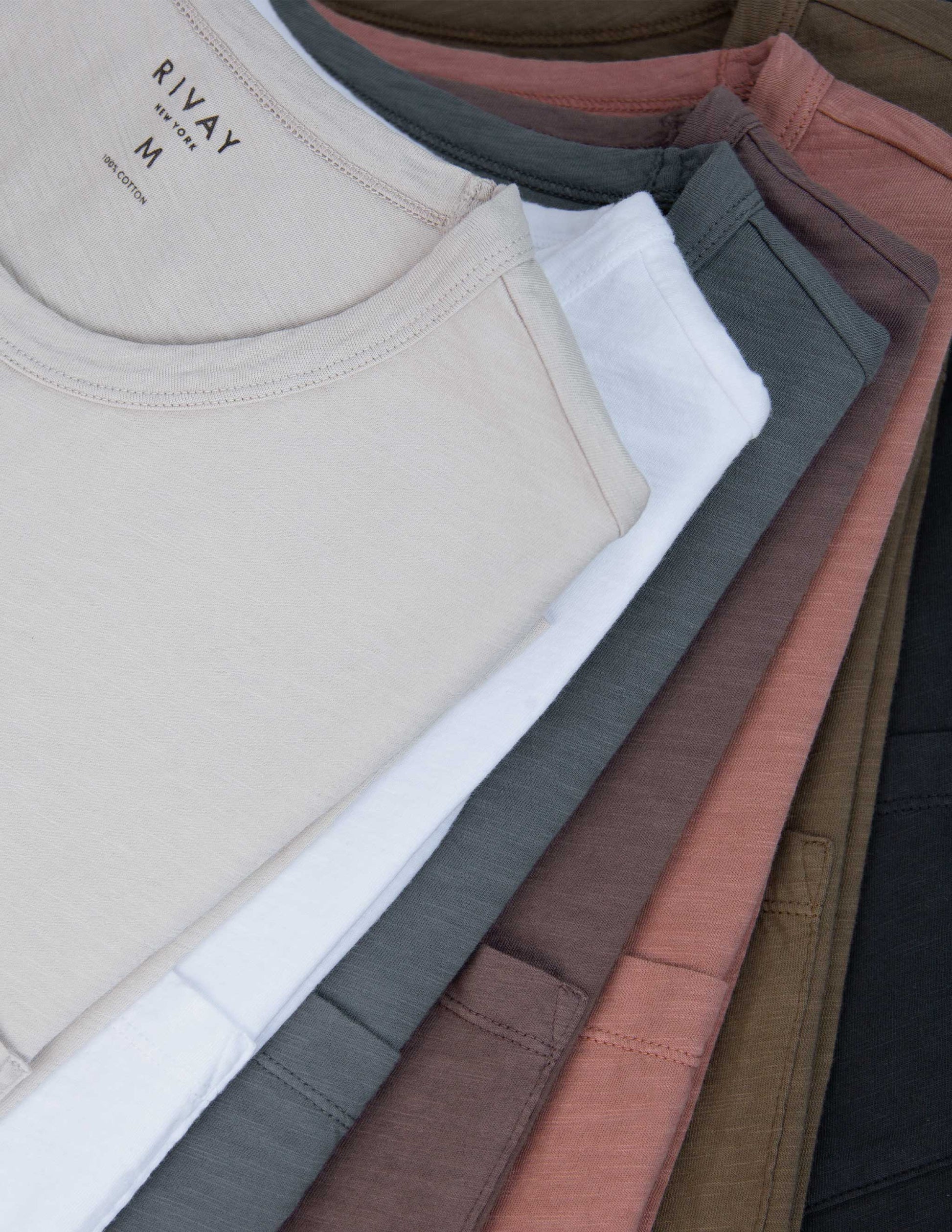Stack of folded Rivay slub t-shirts in various colors