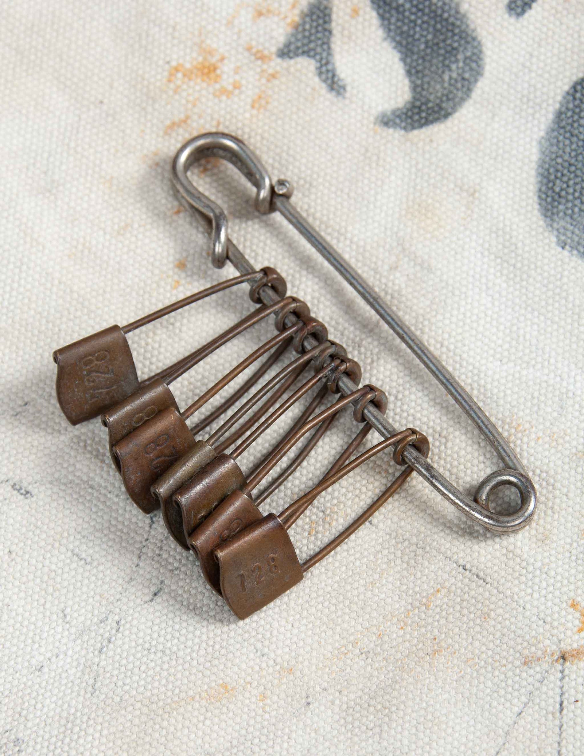 Vintage Safety Pin with Seven Numbered Gear Pins